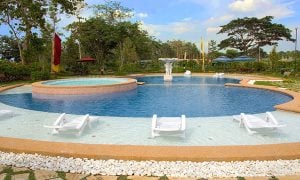 Poolside photo of the clubhouse at Georgia Club Sta. Rosa first class travel | Luxury Homes by Brittany Corporation