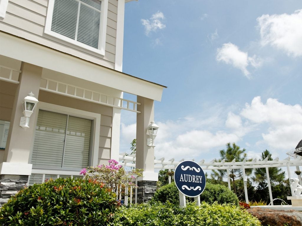 Photo of Audrey signage in front of the luxury home