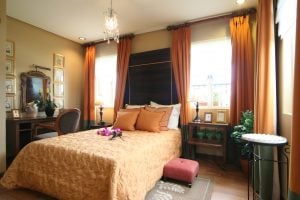 An orange-themed Italian master bedroom in a luxury house in Portofino | Luxury Homes by Brittany Corporation