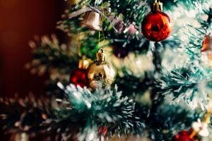 A close up shot of a Christmas ball on a Christmas tree in a luxury house | Luxury Homes by Brittany Corporation