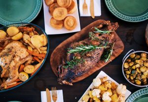 A Noche Buena feast table complete with a roasted chicken, fried fish, egg tarts, diced potatoes, and rice | Luxury Homes by Brittany Corporation