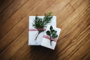 Presents wrapped in white wrapping paper and mistletoe | Luxury Homes by Brittany Corporation