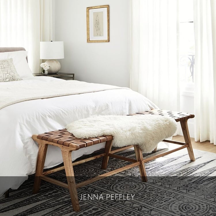 White bed, foot chair, and fur rug on top of it inside a white luxury room in a luxury house and lot | Luxury homes by brittany corporation