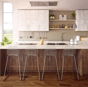 Four barstools in a wide kitchen area with a tabletop stove in a luxury home | Luxury Homes by Brittany Corporation