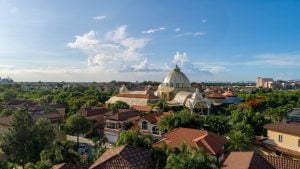 A drone shot of Portofino South, and Amore at Portofino, with Palazzo Verde looming in the background | Luxury Homes by Brittany Corporation