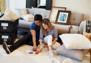 Young artistic asian couple picking colors from a color sampler for the furniture in their newly moved into luxury house | Luxury Homes by Brittany Corporation