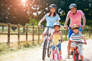 A family biking in the outdoors near their luxury house and lot | Luxury homes by Brittany Corporation