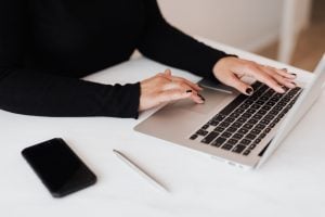 Young working professional wearing black - Luxury homes by Brittany Corporation