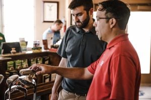 Businessmen and golfers discussing while preparing for another round of golf - Luxury Homes by Brittany Corporation