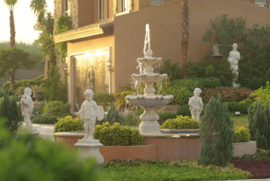 Portofino Heights community shot of rotunda with fountain and statue decors with vibrant greenery that complements the luxury house and lot for sale developments - Luxury Homes by Brittany