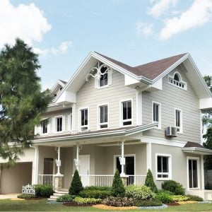 American style white picket fence ready-for-occupancy mansion with three floors, an open garage or carport, many white framed windows and a front porch, next to a grassy front garden consisting of flowers, bushes, pine trees, ferns, and colored rocks | Luxury Homes by Brittany Corporation