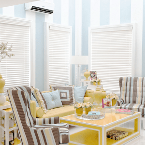 The blue, yellow, and white-themed living room at Audrey, a luxury house model in Augusta, Brittany Sta. Rosa | Luxury Homes by Brittany Corporation