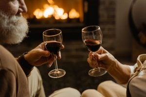 An old couple enjoying the best wine by the fireplace of their luxury home in Tagaytay | Luxury Homes by Brittany Corporation