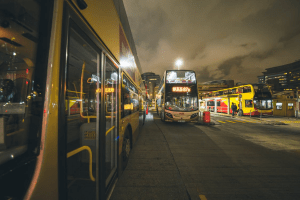 Picture of buses at night transporting people around the city | Luxury Homes by Brittany Corporation