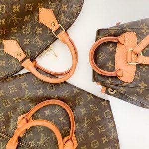 Top view of Louis Vuitton bags of different shapes and sizes against a white surface, including a hand bag and a backpack | Luxury Homes by Brittany Corporation