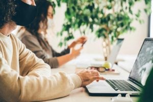 two-young-women-in-their-luxury-house-and-lot-in-the-philippines-on-their-laptops-reading-about-the-proper-growth-mindset-in-the-new-normal