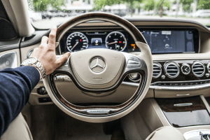 The steering wheel of a Mercedes Benz luxury car evokes the emotions of luxury | Brittany Corporation