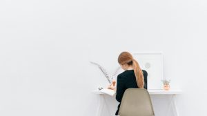 Woman on her work desk while being productive in her luxury home - Luxury homes for sale - Brittany Corporation