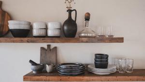 Wooden cupboard filled with black ceramic utensils and plates in a luxury home for sale in the Philippines | Brittany Corporation