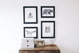 four framed pictures on the wall of a luxury home with motivational quotes and a framed dog picture and cactus figurine below it can serve as a gift for father's day this year | Luxury Homes by Brittany Corporation