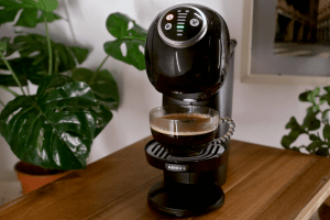 Black modern coffee machine on wooden table | Luxury Homes by Brittany Corporation