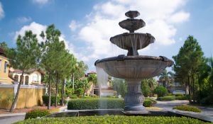 portofino fountain shot among plants and houses | luxury homes by brittany corporation