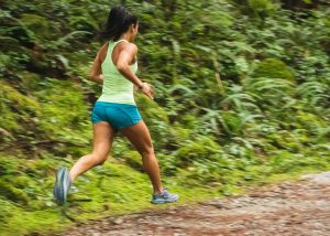 Healthy woman running through a dirt trail to stay fit | Luxury Homes by Brittany Corporation