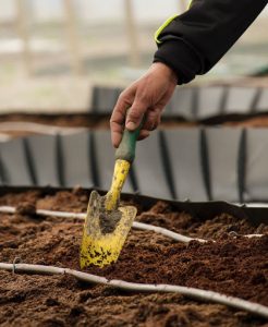 Mini shovel digging soil to composte for healthy plants | Luxury Homes by Brittany