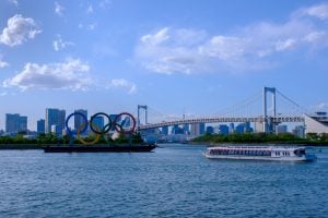 Olympics symbol in Odaiba, Japan with cityscape and cruise.