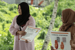 Filipino humanitarian Joy Amer conducting an information campaign on noncommunicable diseases in neglected areas in Mindanao province. Image by CARE Philippines. medical mission | luxury homes by brittany corporation