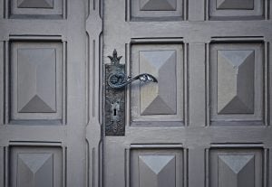 Gray Wooden Closed Door of a Luxury Property for Sale - Brittany Corporation