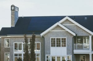 Image of a solar powered luxury house and lot with the solar panels placed on the roof - Brittany Corporation