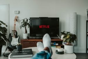 Person wearing white socks while sitting in front of a black flat screen TV  at his luxury house and lot in the Philippines - Brittany Corporation