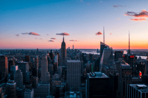 Photo of a sunset scenery with tall buildings and skyscrapers of the city in New York USA - Brittany Corporation - Scenic Destinations around the world