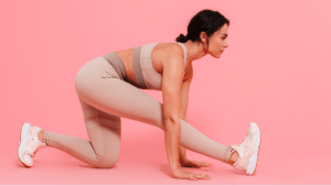 Woman in pink sportswear doing stretching exercises to work out at her luxury home - Brittany Corporation