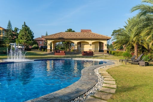 Pristine blue swimming pool with clubhouse from luxury houses and lots in Portofino Alabang. | Luxury homes by brittany corporation.