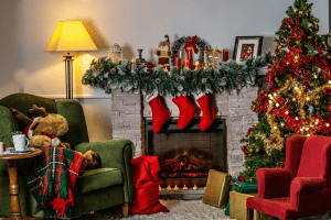 A photo of holiday home decor Christmas-themed living room, featuring green and red chairs, a fireplace, and other bright-colored holiday ornaments | Luxury homes by brittany corporation