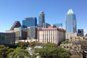 Austin Texas skyline dotted with luxury condominiums amidst the blue sky luxury houses and lots vegan travel | luxury homes by brittany corporation