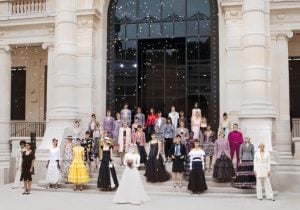 Women of different ethnicities wearing chanel luxury clothes celebrate the finale of the chanel fashion show | luxury homes by brittany corporation