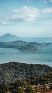 green and brown mountain in the middle of the lake in tagaytay | luxury homes by brittany corporation