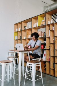 Man using a computer in his luxury home | luxury home by brittany corporation 