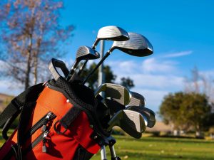 a red golf bag with different types of golf clubs. | Luxury homes by Brittany corporation