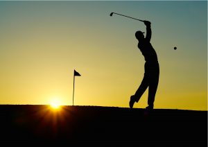 silhouette of a man playing golf. | Luxury homes by brittany corporation 