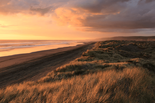 A landscape photograph of a sprawling coast during the golden hour | Luxury Homes by Brittany Corporation