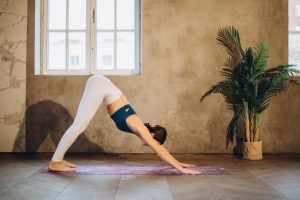 Downward Dog outdoor yoga position inside luxury house and lot properties | Luxury Homes by Brittany Corporation