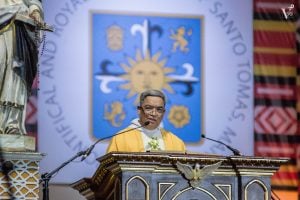 Herminio Dagohoy in yellow vestments celebrating mass on a gilded lechter | Luxury Homes by Brittany Corporation