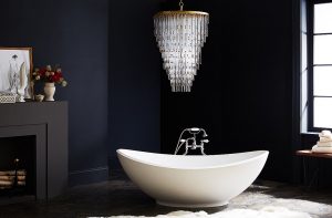 Luxury Chandelier in black-walled bathroom with big white tub in a luxury house and lot | Luxury Homes by Brittany Corporation