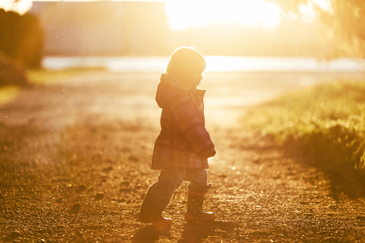 Child walking in open field | Luxury Homes by Brittany Corporation