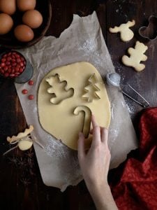 cookie cutter on dough with caucasian lady's hand in a luxury home kitchen | Luxury Homes by Brittany Corporation