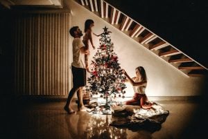 family fixing the christmas tree in their luxury home | luxury Homes by brittany corporation